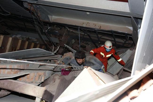 Man rescued 69 hours after China hotel collapse, 9 still missing